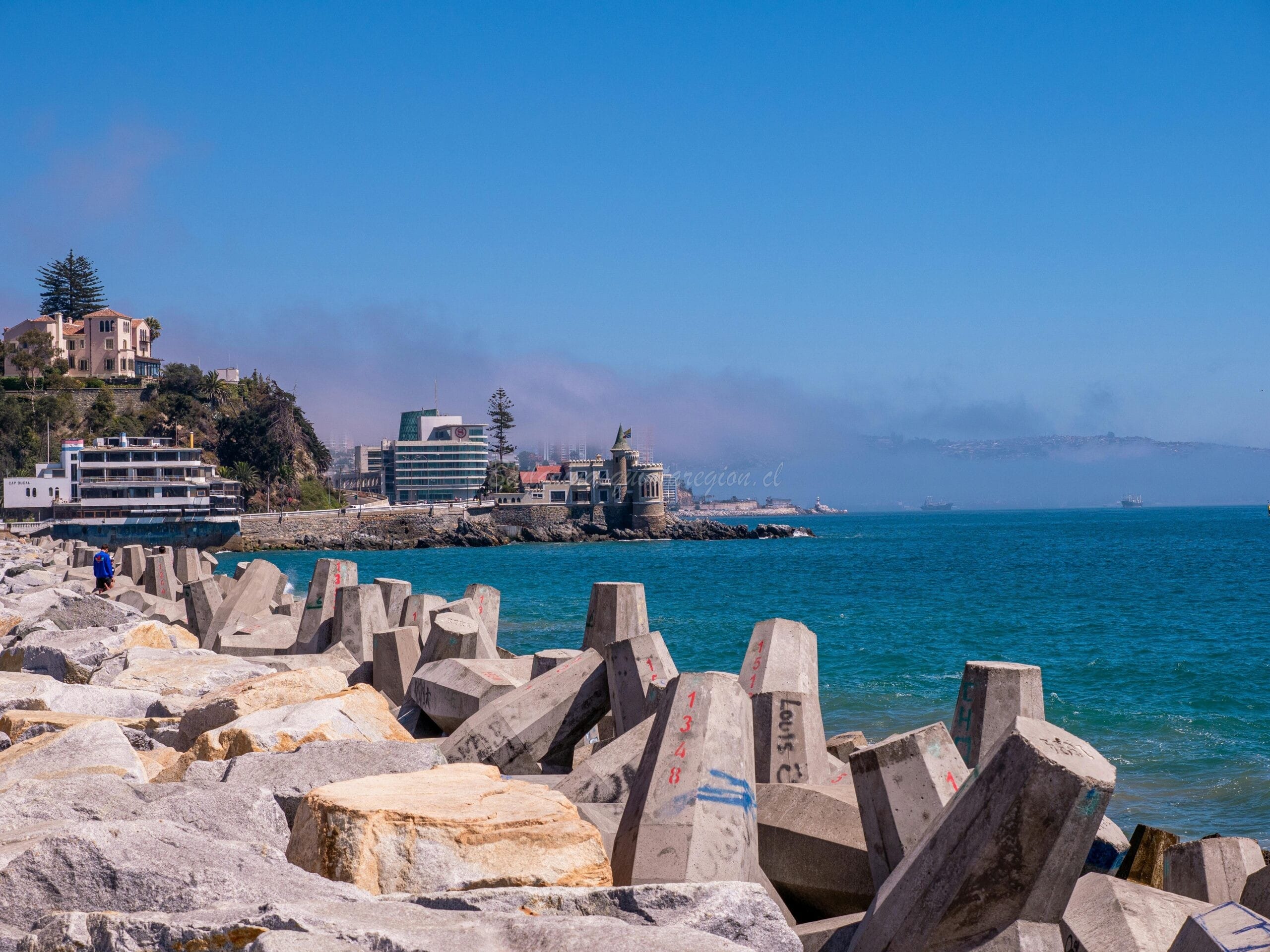 Concrete breakwaters along the coast in Viña del Mar, Chile on a sunny day.