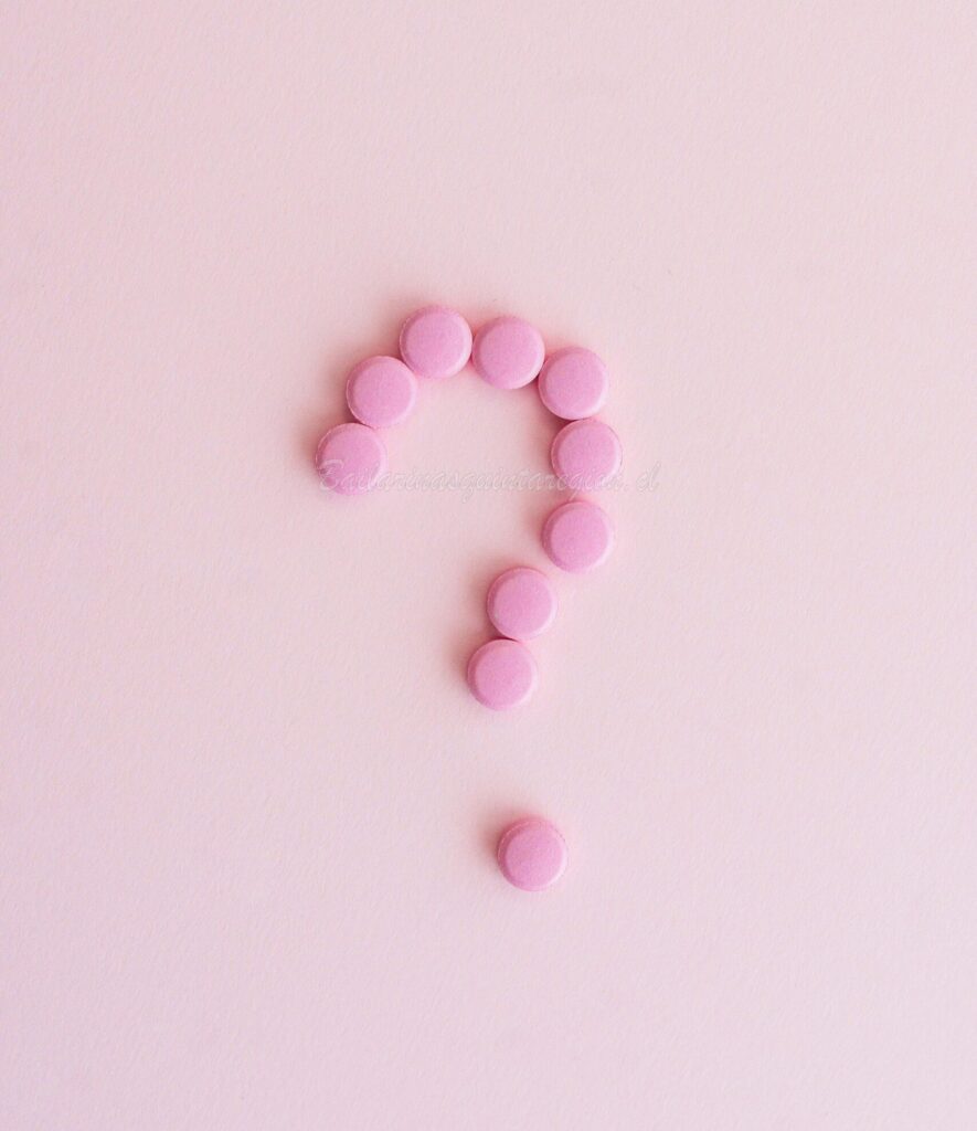 Pink pills forming a question mark on a pastel surface, symbolizing uncertainty in health decisions.